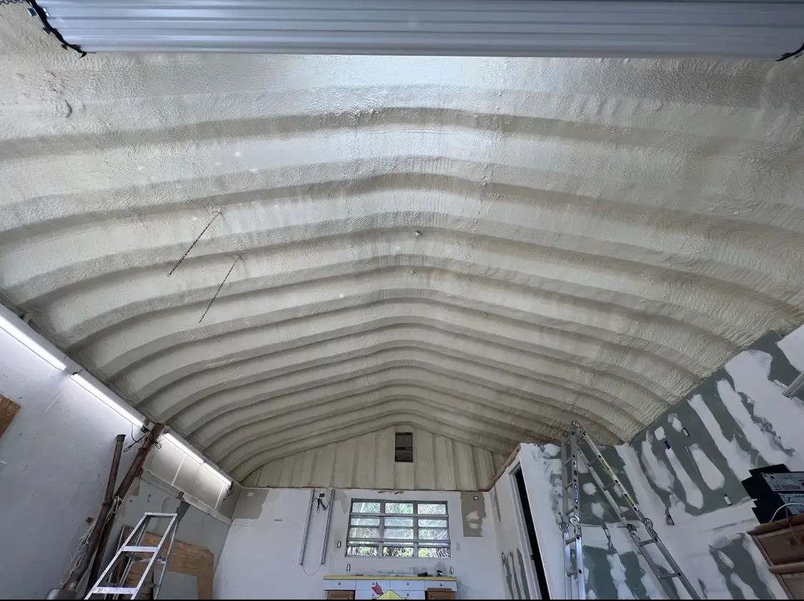 Spray polyurethane foam applied to the underside of a metal roof deck in Monson